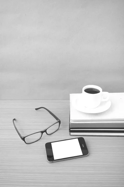 coffee,phone,stack of book and eyeglasses