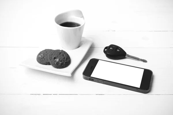 Coffee cup with cookie,phone and car key black and white color — Stock Photo, Image