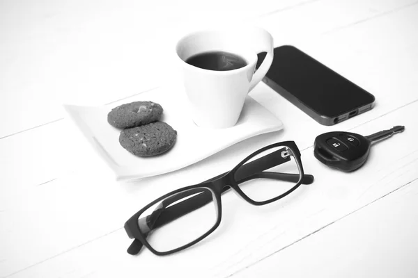 Taza de café con galletas, teléfono, anteojos y la llave del coche negro y wh — Foto de Stock