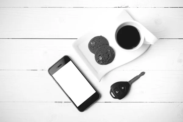 Coffee cup with cookie,phone and car key black and white color — Stock Photo, Image