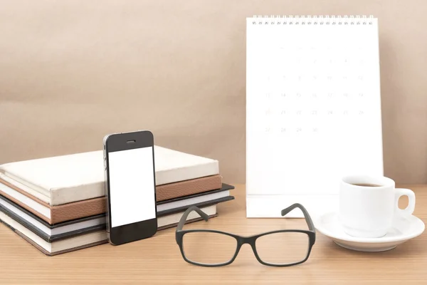 coffee,phone,eyeglasses,stack of book and calendar