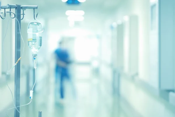 Medical drip in the blurred background of doctors — Stock Photo, Image