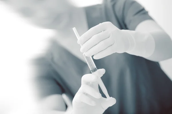 Nurse with a syringe in hands — Stock Photo, Image