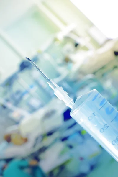 Filled syringe on the patient's background — Stock Photo, Image