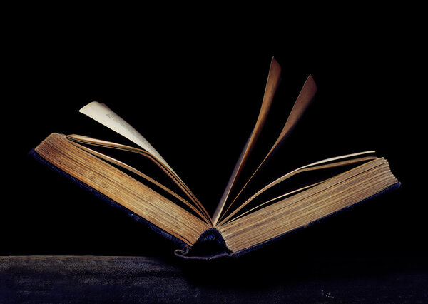 Open book on the black background.