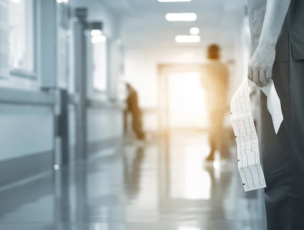 Doctor with ECG in hospital hall — Stock Photo, Image