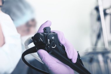 Macro of endoscopic instrument in the hands of a medical doctor clipart