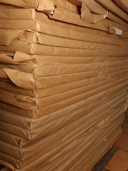 Stack of paper-wrapped shipments in storage.