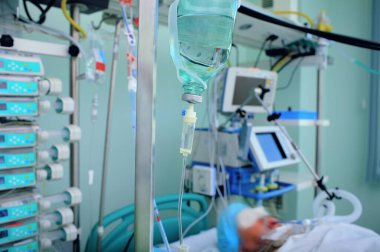 Yoğun bakım ünitesi. Kurtarma ekipmanlarına bağlı yatağında hasta var..