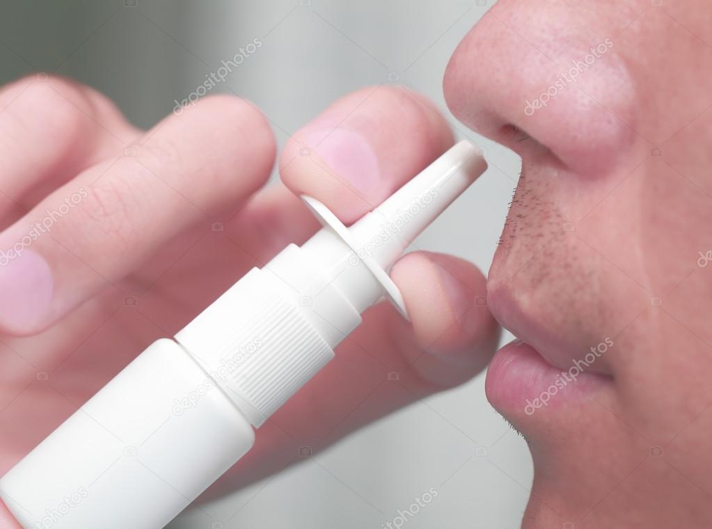 Man uses a nasal spray 