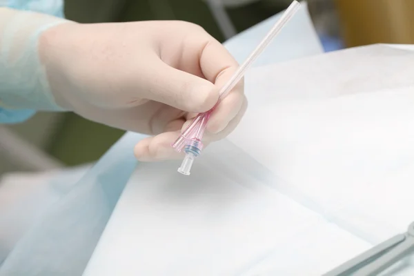 Doctor with a big medical needle — Stock Photo, Image