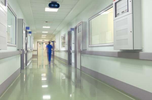 Hospital corridor with blurred figures of the medical staff 