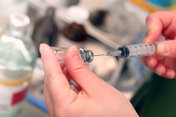 Hospital nurse fills a syringe medication from a vial — Stock Photo, Image
