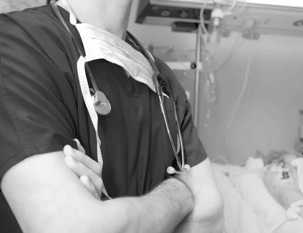 Doctor in intensive care ward concept in monochrome — Stock Photo, Image