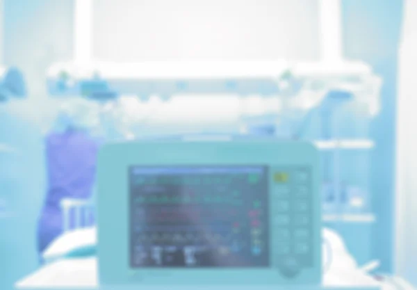 Medical background with a monitor in a hospital ward. Blurred he — Stock Photo, Image