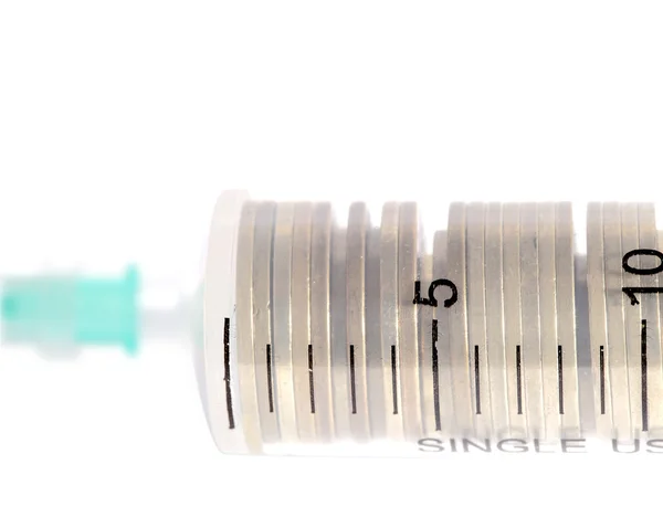 Stack of coins in the medical syringe — Stock Photo, Image