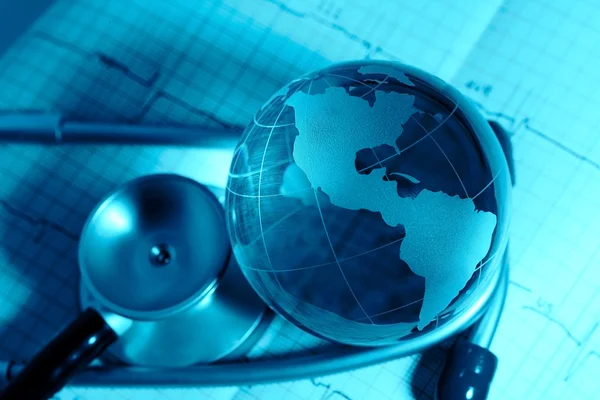 Glass globe and stethoscope on a background ECG — Stock Photo, Image