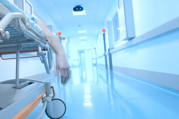 Lifeless dangling hand in the interior of the hospital — Stock Photo, Image