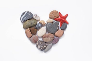 kalp, doğal deniz taşlarından, deniz yıldızlarından ve deniz kabuklarından yapılmış beyaz arka planda, tatil kavramı, deniz yolculuğu, minimalizm
