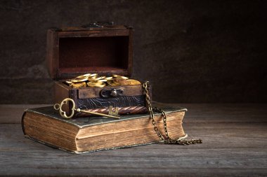 vintage wooden chest full of gold coins, treasure key, pirate treasure concept clipart