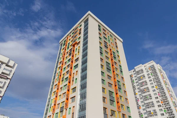 Modern residential high-rise buildings against a clear blue sky. Construction of new multi-storey residential buildings