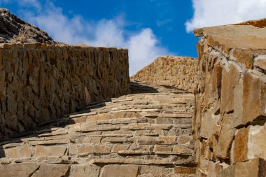 Bulutlu gökyüzüne karşı taş merdiven. Güneşli bir yaz günü. Ön görünüm.