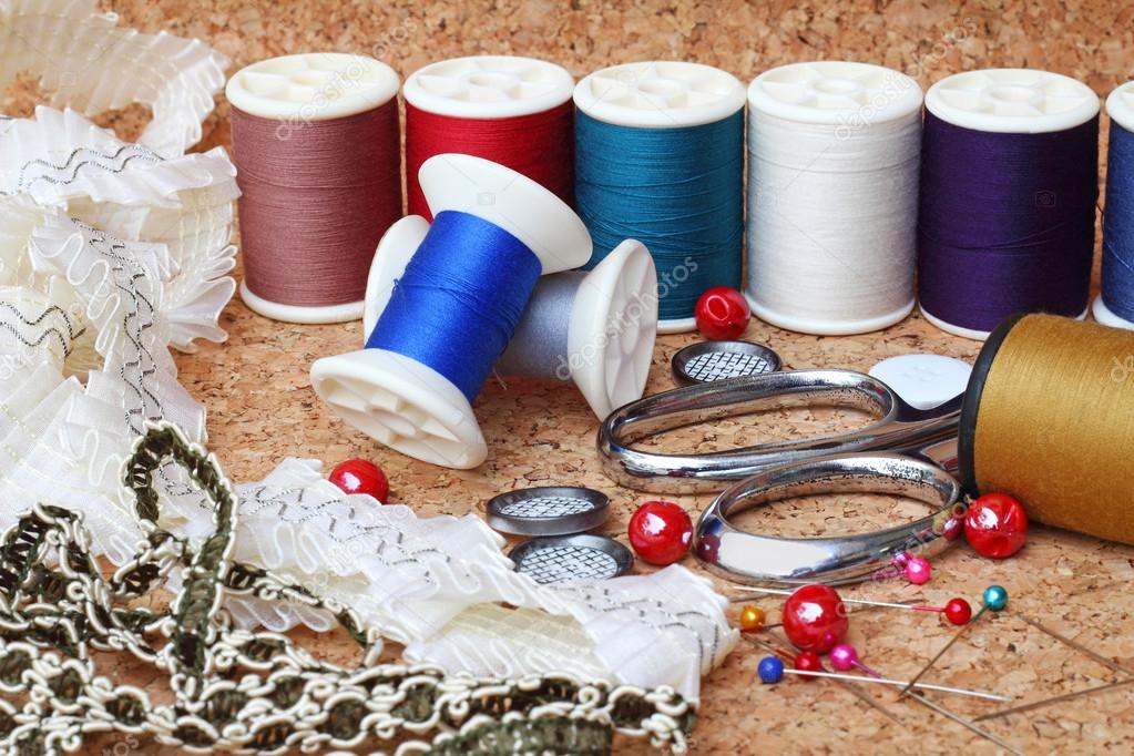 Sewing items: buttons, material, measuring tape, bobbins, button