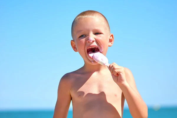 Мальчик облизывает мороженое — стоковое фото