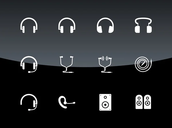 Iconos de auriculares sobre fondo negro . — Vector de stock