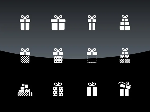 Christmas gift box icons on black background. — Stock Vector