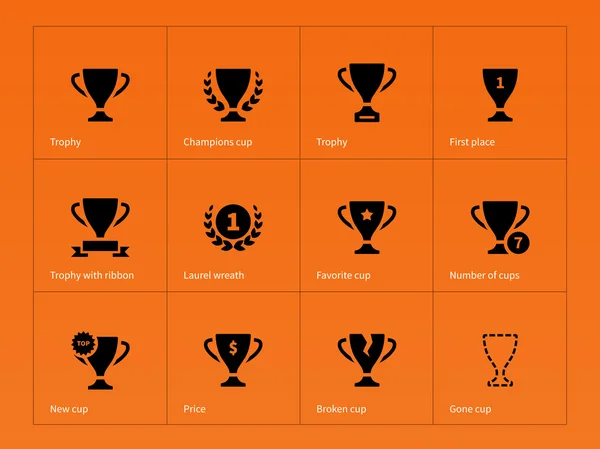 Trofee award pictogrammen op oranje achtergrond. — Stockvector