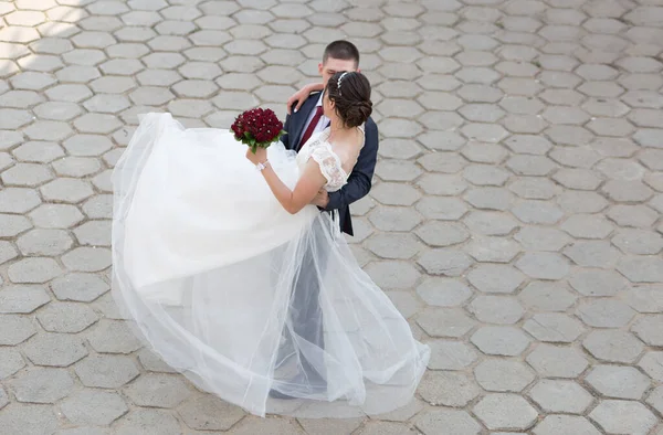 the groom circles his bride in a dance in his arms. happy people in love.