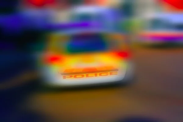 Abstrato colorido fundo borrão de um carro de polícia — Fotografia de Stock