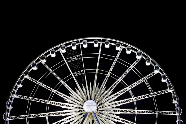 Large ferris wheel illuminated in motion at night — Stock Photo, Image