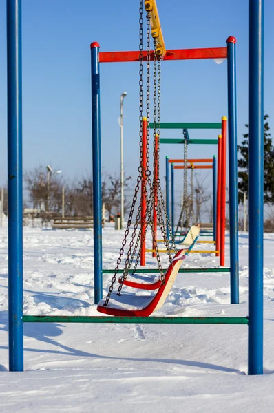 Scena invernale con coppia di altalene nel parco — Foto Stock