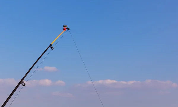 Top fishing rod on blue sky — Stock Photo, Image