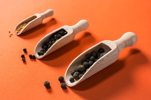 Wooden spoons with allspice berries spice, black pepper grains a — Stock Photo, Image