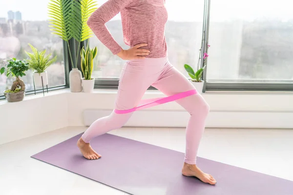 Weerstandsband fitness home workout vrouw doen lunges met behulp van lus banden voor benen oefening stap voor-en zijkant oefeningen met de band elastische. Glutenspier activatie voor dijen cellulitis — Stockfoto