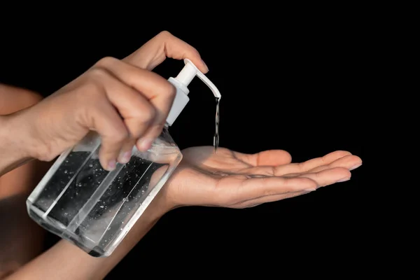 Coronavirus prevetion by using hand sanitizer when outside in public businesses. Woman putting gel in hands for protective measure against corona virus — Stock Photo, Image