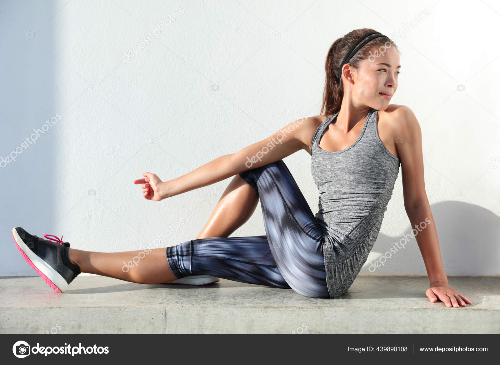 Fitness woman stretching legs doing pilates leg stretches