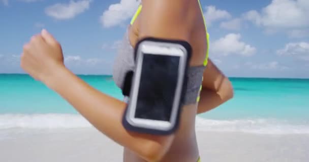 Fitness woman running fast wearing phone armband — Stock Video