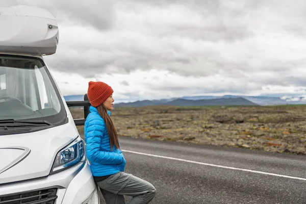 RV camper trailer travel woman driving motorhome camping van on Iceland road trip. Asian tourist driver taking break on adventure fall autumn vacation looking at nature landscape. — Stock Photo, Image