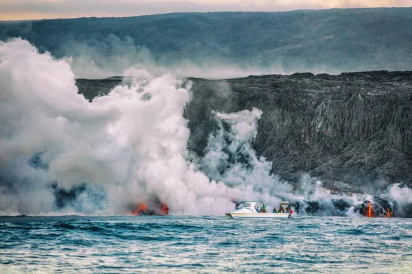 Excursión en barco de erupción del volcán Hawaii. Los turistas en crucero por el océano viajan observando la lava que llega al agua con humos tóxicos. Excursión peligrosa en Big Island —  Fotos de Stock