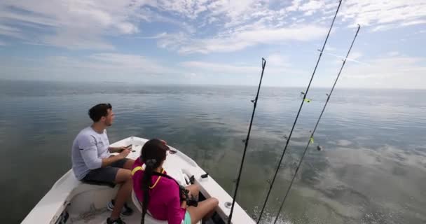 Fishing from boat - people going fishing with fishing rod on open water — Stock Video