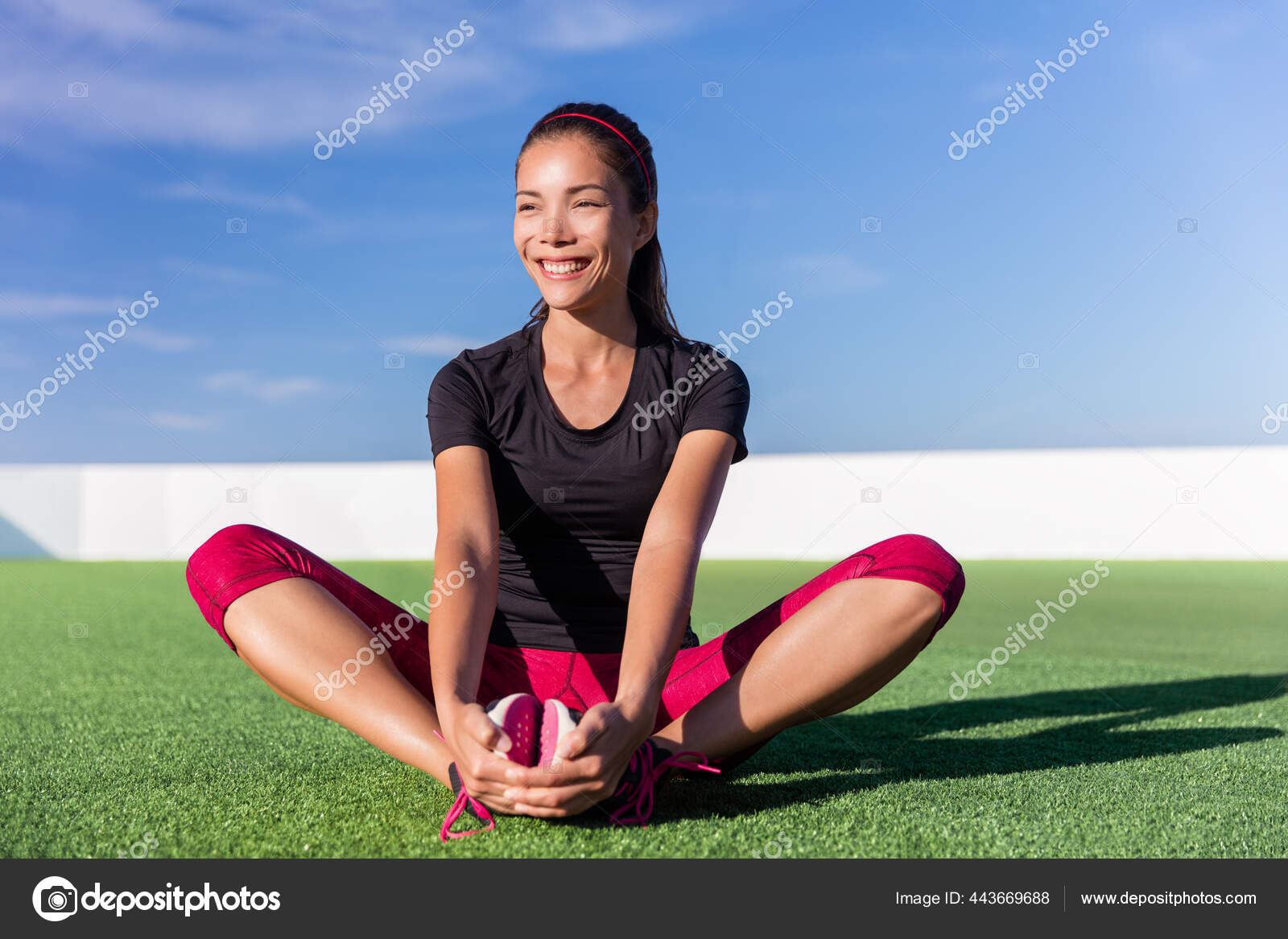 Happy fitness Asian woman stretching legs in park Stock Photo by ©Maridav  443669688