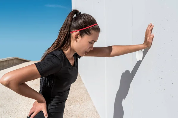 Tired athlete runner breathing after hard exercise