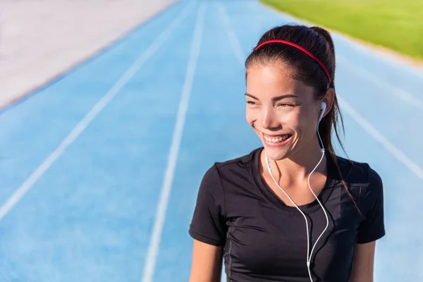 Happy track running girl runner listening to music — Stock Photo, Image