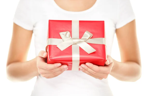 Gift or Christmas present. Woman showing and givng red gift with ribbon. Closeup of isolated on white background. — Stock Photo, Image