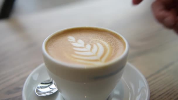 Coffee Cappuccino cup top view with coffee latte art in cafe — Stock Video