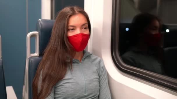 Žena s obličejovou maskou ve veřejné dopravě během pandemie koronaviru Covid-19. Koncept masky obličeje s dojíždějícím vlakem. Multiracial woman passenger using face mask on commute. — Stock video